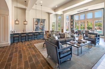 A modern living room with a dark wood floor and a large sectional sofa.